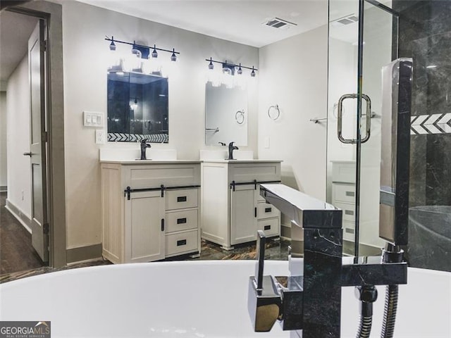 664 Florence Pl NW, Atlanta, GA 30318 - bathroom with a shower stall, a freestanding bath, and two vanities