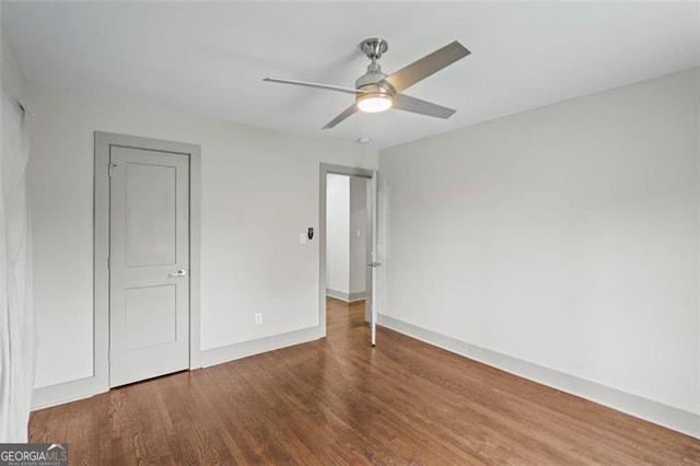 664 Florence Pl NW, Atlanta, GA 30318 - unfurnished bedroom with wood finished floors, baseboards, and ceiling fan