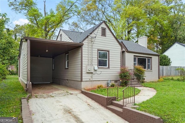 664 Florence Pl NW, Atlanta, GA 30318 - view of front of property with concrete driveway, an attached carport, and a chimney