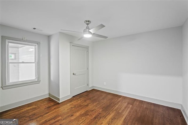 664 Florence Pl NW, Atlanta, GA 30318 - spare room featuring dark wood-style flooring, baseboards, and a ceiling fan