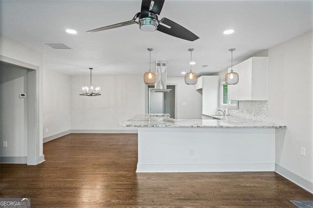 664 Florence Pl NW, Atlanta, GA 30318 - kitchen with light stone counters, white cabinets, ceiling fan, a peninsula, and a sink