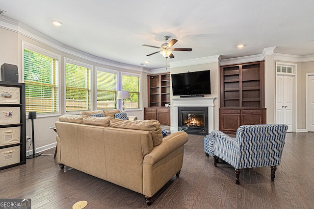 4815 Edgemoore Trce, Cumming, GA 30040 - living area featuring crown molding, a ceiling fan, a glass covered fireplace, dark wood-style floors, and recessed lighting