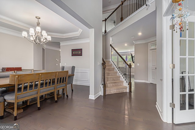 4815 Edgemoore Trce, Cumming, GA 30040 - dining area featuring ornamental molding, a chandelier, stairway, and wood finished floors