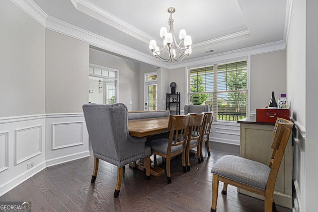 4815 Edgemoore Trce, Cumming, GA 30040 - dining space featuring a chandelier, a tray ceiling, ornamental molding, dark wood finished floors, and wainscoting