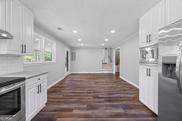 1766 Washington Hwy, Elberton, GA 30635 - kitchen with stainless steel appliances, recessed lighting, ornamental molding, dark wood-style floors, and white cabinets