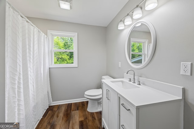 1766 Washington Hwy, Elberton, GA 30635 - full bath with wood finished floors, toilet, baseboards, and vanity