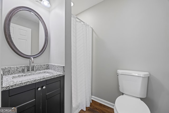 1766 Washington Hwy, Elberton, GA 30635 - full bathroom featuring toilet, wood finished floors, baseboards, and vanity