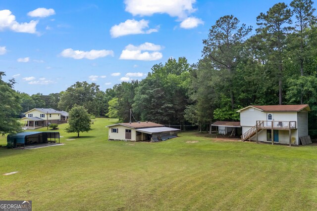 1766 Washington Hwy, Elberton, GA 30635 - view of grassy yard with a detached carport, stairway, and a wooden deck