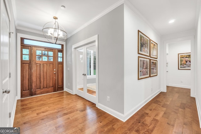 377 Parker Rd, Mcdonough, GA 30252 - entryway featuring a chandelier, light wood finished floors, crown molding, and baseboards