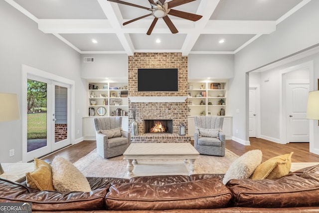 377 Parker Rd, Mcdonough, GA 30252 - living room with wood finished floors, a ceiling fan, coffered ceiling, a fireplace, and beamed ceiling