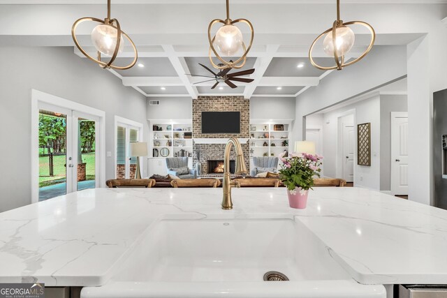 377 Parker Rd, Mcdonough, GA 30252 - kitchen featuring a sink, a ceiling fan, open floor plan, a brick fireplace, and built in features