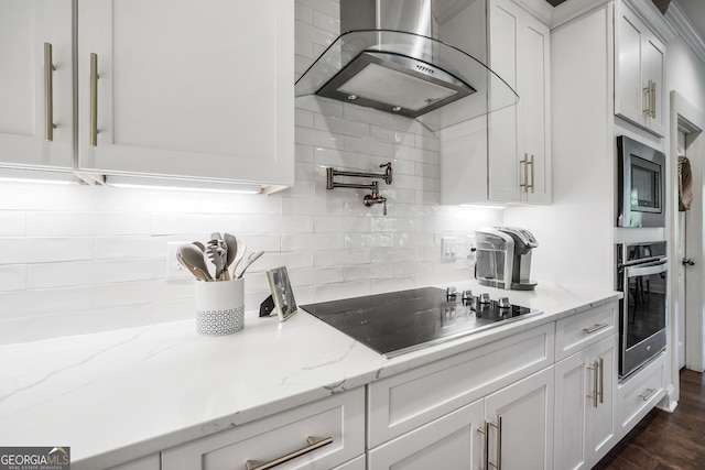 377 Parker Rd, Mcdonough, GA 30252 - kitchen with appliances with stainless steel finishes, wall chimney exhaust hood, white cabinetry, and decorative backsplash
