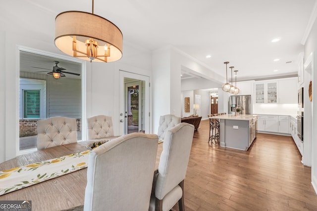 377 Parker Rd, Mcdonough, GA 30252 - dining room featuring a ceiling fan, ornamental molding, light wood-type flooring, and recessed lighting