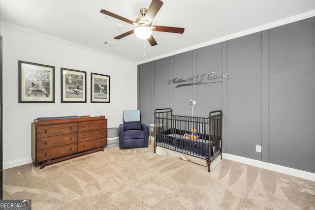 377 Parker Rd, Mcdonough, GA 30252 - bedroom with carpet floors, crown molding, a crib, a ceiling fan, and baseboards