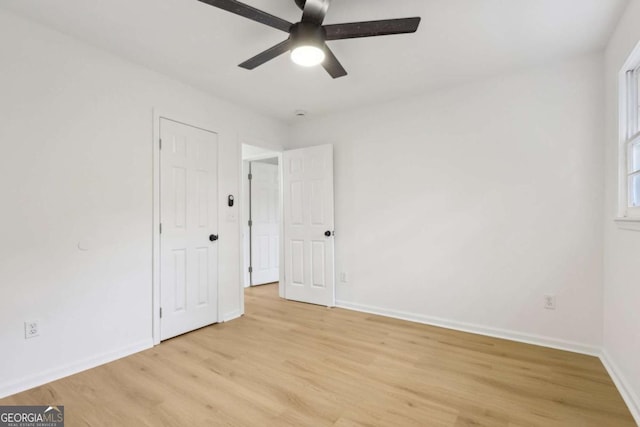 2765 Ocean Valley Dr, Atlanta, GA 30349 - unfurnished bedroom featuring light wood-style floors, baseboards, and a ceiling fan