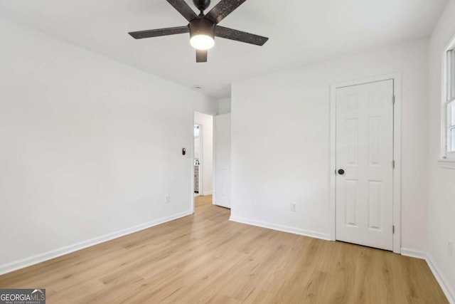 2765 Ocean Valley Dr, Atlanta, GA 30349 - empty room with light wood finished floors, ceiling fan, and baseboards