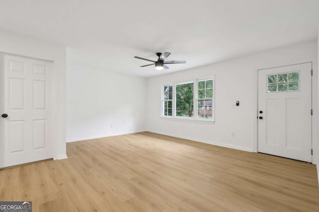 2765 Ocean Valley Dr, Atlanta, GA 30349 - entrance foyer with a ceiling fan, plenty of natural light, light wood finished floors, and baseboards