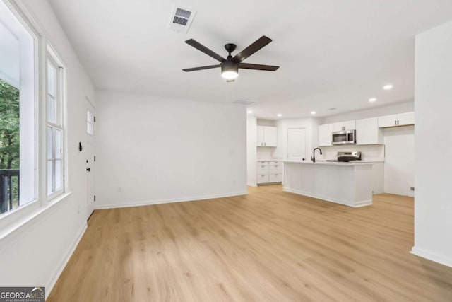 2765 Ocean Valley Dr, Atlanta, GA 30349 - unfurnished living room with a sink, healthy amount of natural light, light wood finished floors, and recessed lighting