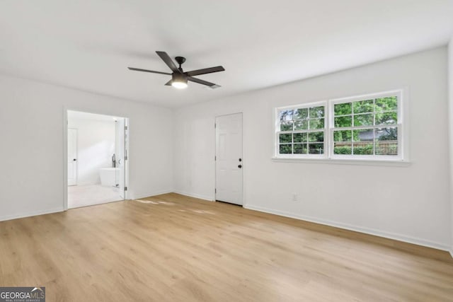 2765 Ocean Valley Dr, Atlanta, GA 30349 - spare room with light wood-style floors, ceiling fan, and baseboards