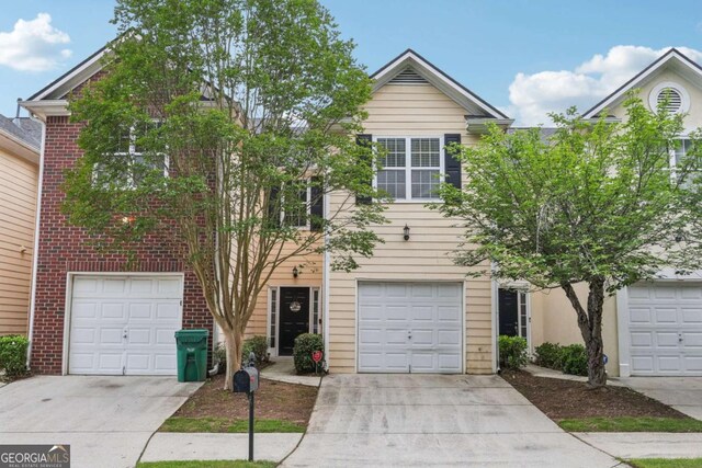 7077 Biltmore Trce, Lithonia, GA 30058 - view of front facade featuring driveway, brick siding, and a garage