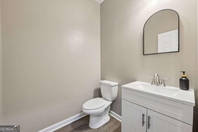 7077 Biltmore Trce, Lithonia, GA 30058 - half bathroom with vanity and wood finished floors