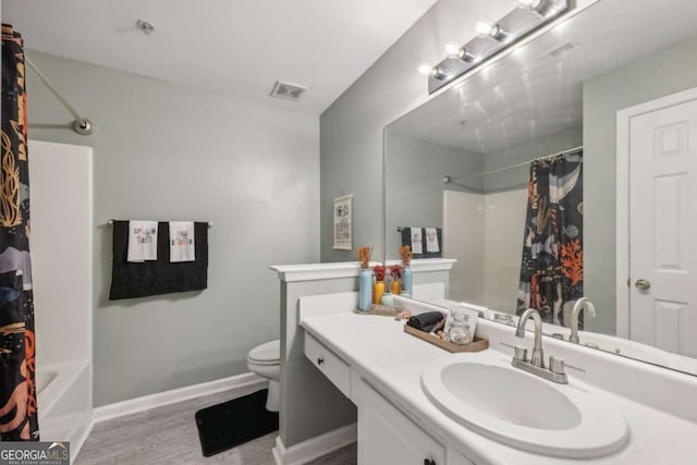 7077 Biltmore Trce, Lithonia, GA 30058 - bathroom featuring vanity, wood finished floors, and shower / tub combo