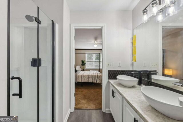7077 Biltmore Trce, Lithonia, GA 30058 - ensuite bathroom featuring a stall shower, double vanity, a ceiling fan, and wood finished floors