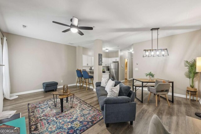 7077 Biltmore Trce, Lithonia, GA 30058 - living area featuring wood finished floors and a ceiling fan