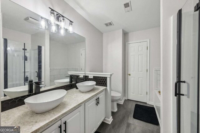 7077 Biltmore Trce, Lithonia, GA 30058 - bathroom featuring a stall shower, a tub, double vanity, and tile patterned floors