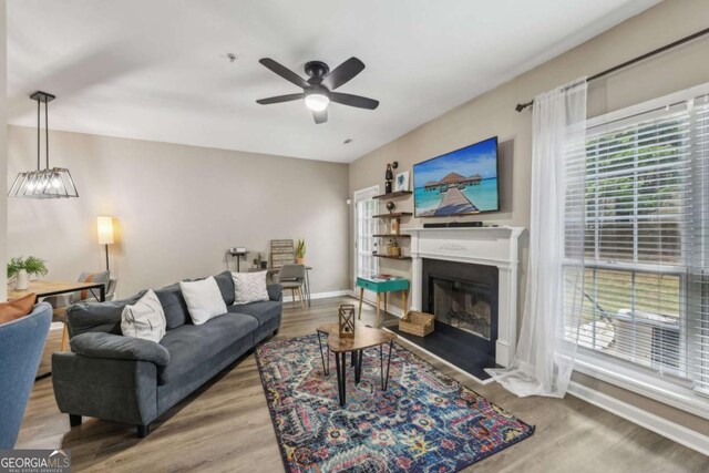 7077 Biltmore Trce, Lithonia, GA 30058 - living room featuring a ceiling fan, wood finished floors, and a fireplace