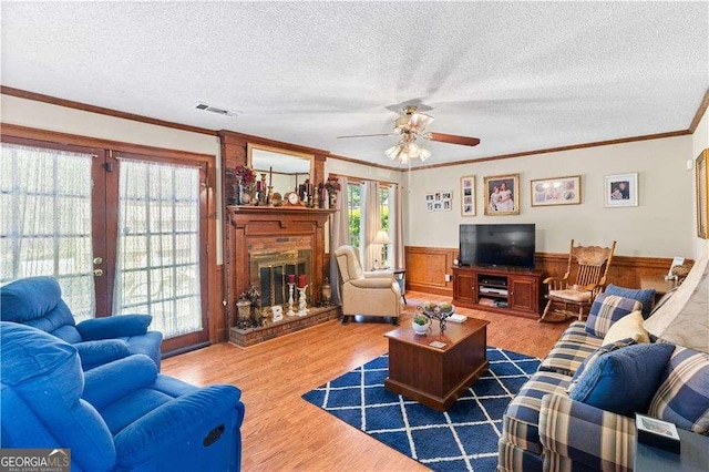 3472 Honeycomb Dr SE, Conyers, GA 30094 - living room with wood finished floors, french doors, ceiling fan, a fireplace, and a textured ceiling