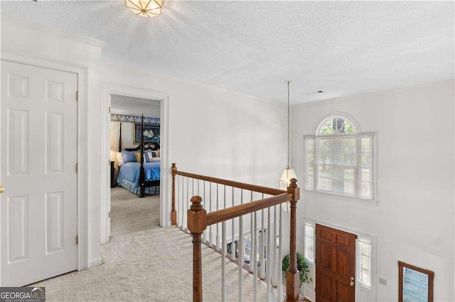3472 Honeycomb Dr SE, Conyers, GA 30094 - hallway with carpet, a textured ceiling, and an upstairs landing