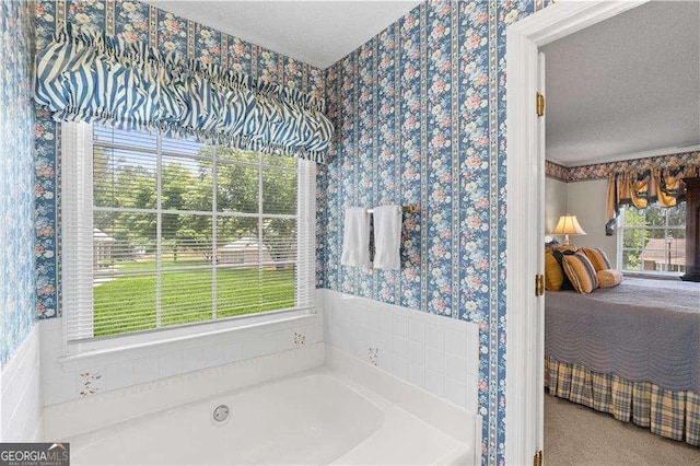 3472 Honeycomb Dr SE, Conyers, GA 30094 - bathroom featuring wallpapered walls, connected bathroom, a textured ceiling, and a garden tub