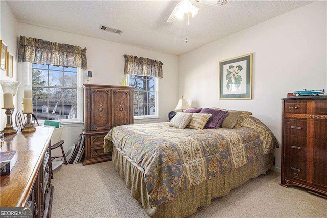 3472 Honeycomb Dr SE, Conyers, GA 30094 - bedroom featuring light colored carpet, a textured ceiling, and ceiling fan