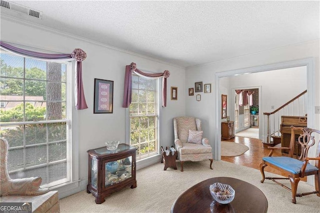 3472 Honeycomb Dr SE, Conyers, GA 30094 - living area with a textured ceiling, ornamental molding, and stairway