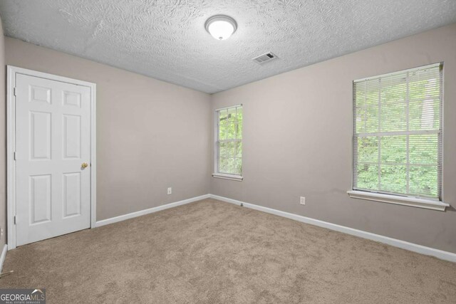 470 Piney Way SW, Atlanta, GA 30331 - carpeted spare room with baseboards and a textured ceiling