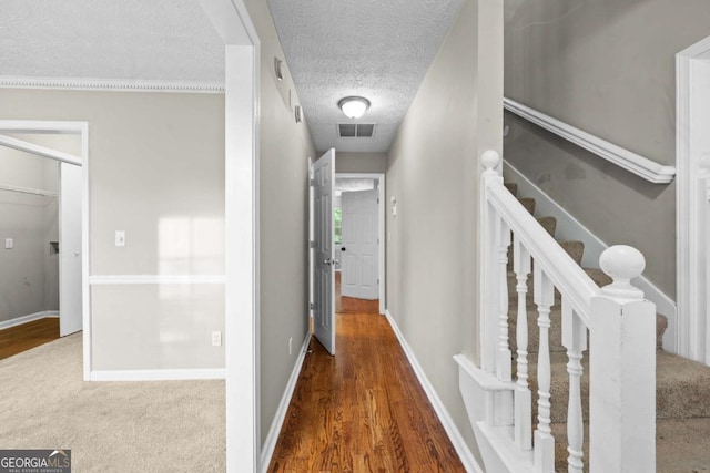 470 Piney Way SW, Atlanta, GA 30331 - hallway featuring wood finished floors, a textured ceiling, baseboards, and stairs