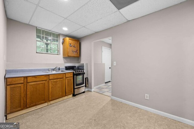 470 Piney Way SW, Atlanta, GA 30331 - kitchen featuring stainless steel gas range, a sink, light countertops, brown cabinetry, and light flooring
