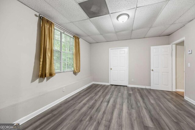 470 Piney Way SW, Atlanta, GA 30331 - spare room with a paneled ceiling, dark wood-style floors, and baseboards