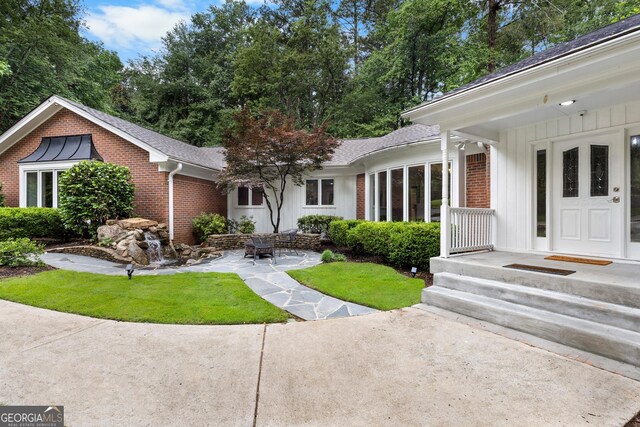 630 Buttercup Trce, Alpharetta, GA 30022 - view of front of home featuring brick siding, board and batten siding, a shingled roof, and a front lawn