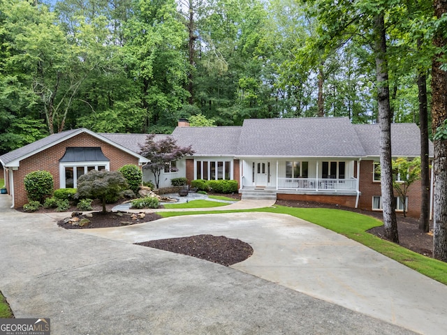 630 Buttercup Trce, Alpharetta, GA 30022 - ranch-style house with covered porch, brick siding, a chimney, concrete driveway, and roof with shingles