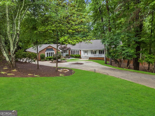 630 Buttercup Trce, Alpharetta, GA 30022 - ranch-style house with curved driveway, a front yard, a porch, and brick siding