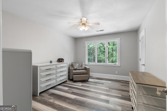 630 Buttercup Trce, Alpharetta, GA 30022 - sitting room with ceiling fan, a textured ceiling, wood finished floors, and baseboards