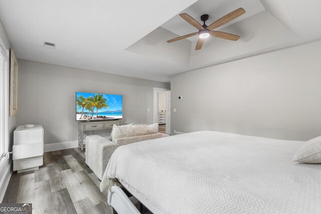 630 Buttercup Trce, Alpharetta, GA 30022 - bedroom featuring wood finished floors, a tray ceiling, a ceiling fan, and baseboards