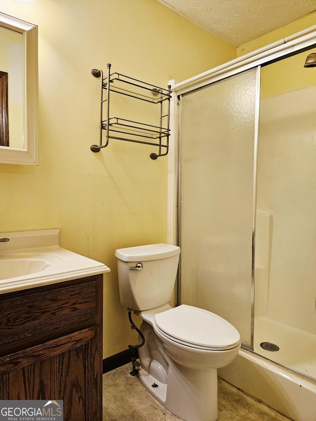 6698 Cameron Rd, Morrow, GA 30260 - bathroom with a stall shower, vanity, toilet, and a textured ceiling