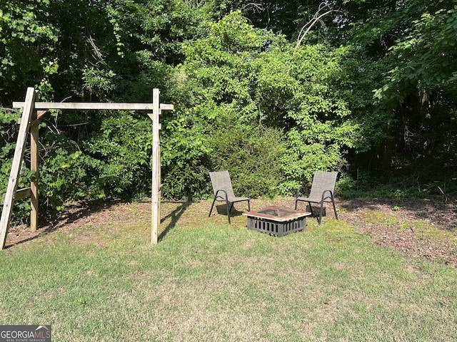 1047 Taso Trl, Acworth, GA 30101 - view of green lawn with an outdoor fire pit