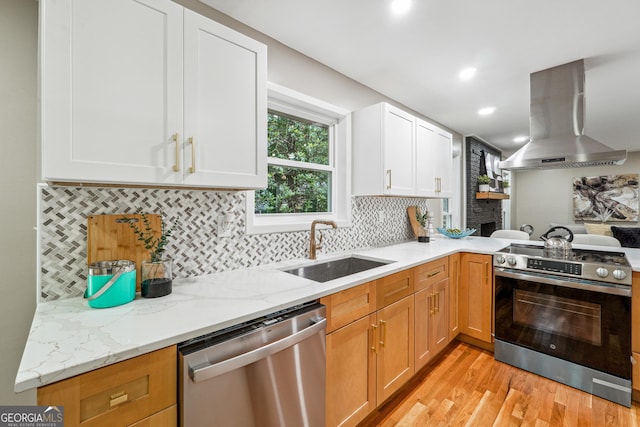 2771 Smithsonia Way, Tucker, GA 30084 - kitchen with stainless steel appliances, island range hood, a sink, light wood finished floors, and light stone countertops