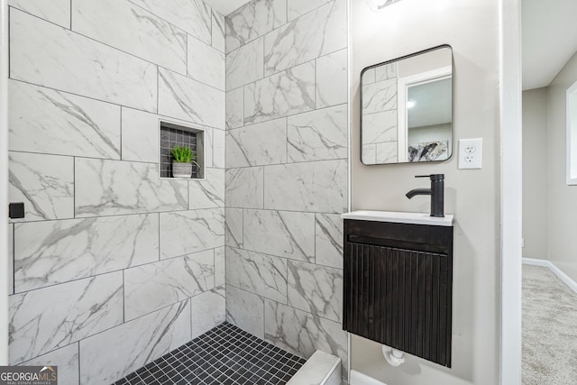 2771 Smithsonia Way, Tucker, GA 30084 - bathroom featuring vanity, a tile shower, and baseboards
