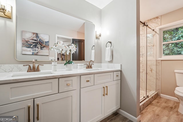 2771 Smithsonia Way, Tucker, GA 30084 - bathroom featuring toilet, a stall shower, double vanity, and baseboards