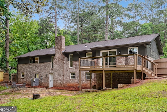 2771 Smithsonia Way, Tucker, GA 30084 - back of property with a yard, a chimney, an outdoor fire pit, and a deck